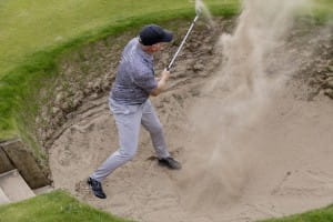 Golfer hitting his way out of bunker at SBH Scotland Golf Day