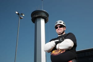 Adrian Milne stands in front of Northern Lights Tower before he abseils it.