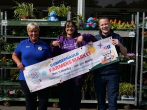 Doreen Reid of Tesco, Adeeba Ahmad of SBH Scotland and Daniel Meechan of IRN BRU pose for a photo promoting the Cumbernauld Farmers Market