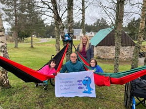 Mark Maclennan posing with SBH Scotland members for a cheque presentation at activity weekend in Badaguish