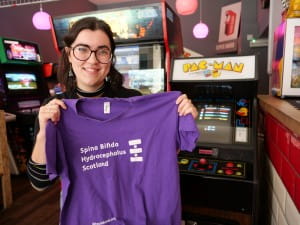General Manager of Super Bario Chloe Magee holds up SBH Scotland t-shirt