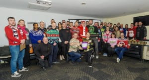 Over 30 Members of BNI Evolution networking group pose together in Christmas jumpers