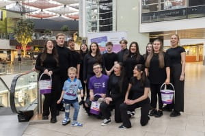 groups of young people pose for photo with young boy to promote charity SBH Scotland in St Enoch Centre.