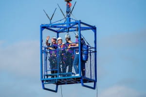 participants are lifted in crane to zipslide start point