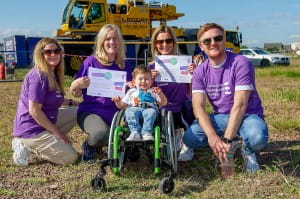 Heaton family pose with certificates after zipslide