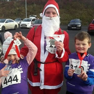 a family dressed as santas for the Cumbernauld Christmas Cracker event