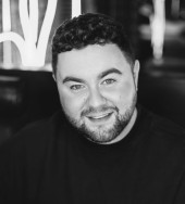 Black and white head and shoulders image of Adam Stewart
