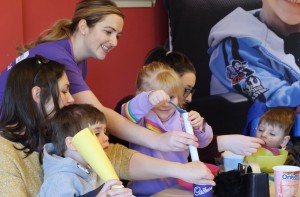 emily pouring lentils at a childrens group