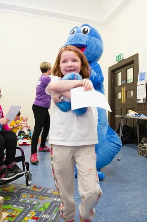 An SBH scotland member is delighted with her Spiney the Diney toy and certificate