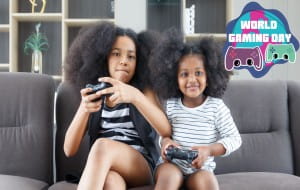 kids sat on couch playing a game