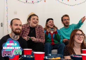 group of friends sat on couch gaming