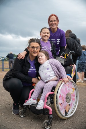 2 girls pose with their mum and aunty at Zipslide event