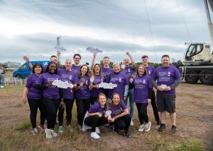 Chisholm Hunter Team pose in front of zipslide crane